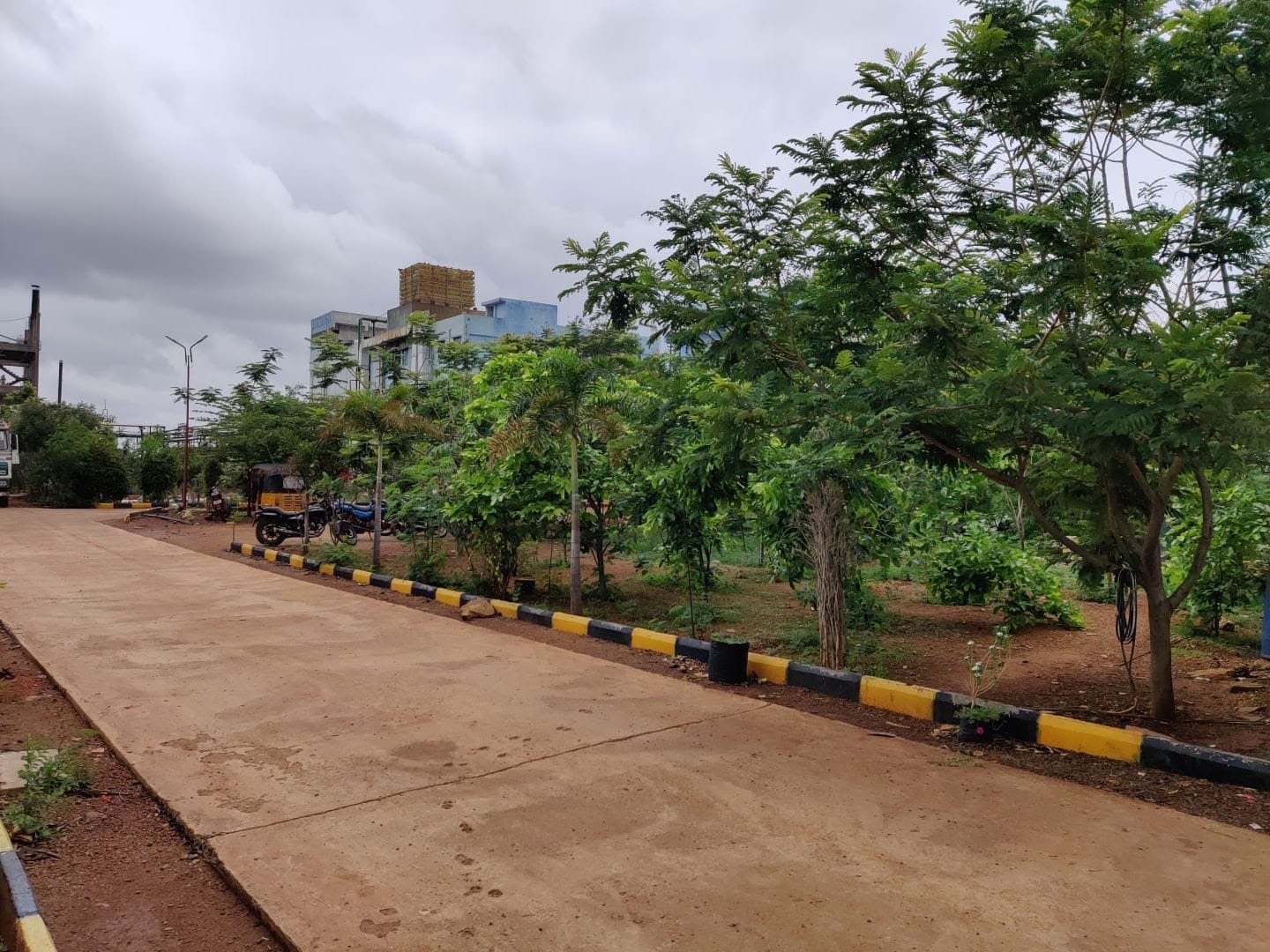 Sritha Chems campus entrance with landscaped road and facility buildings